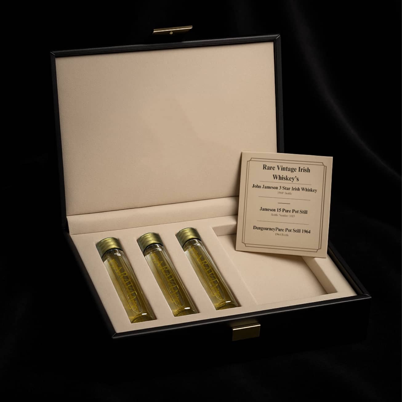 Three bottles of rare vintage Irish whiskey in a display case 