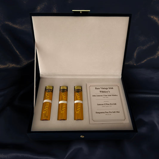 Three bottles of rare vintage Irish whiskey in a display case 